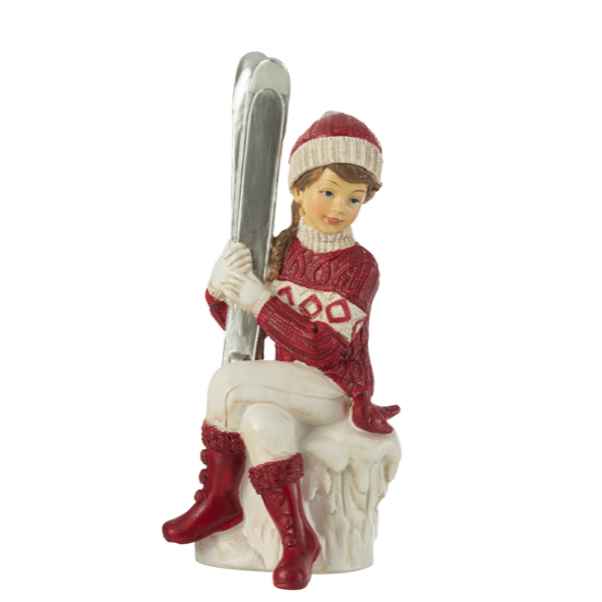 Fille en Ski Assise Rouge et Blanche